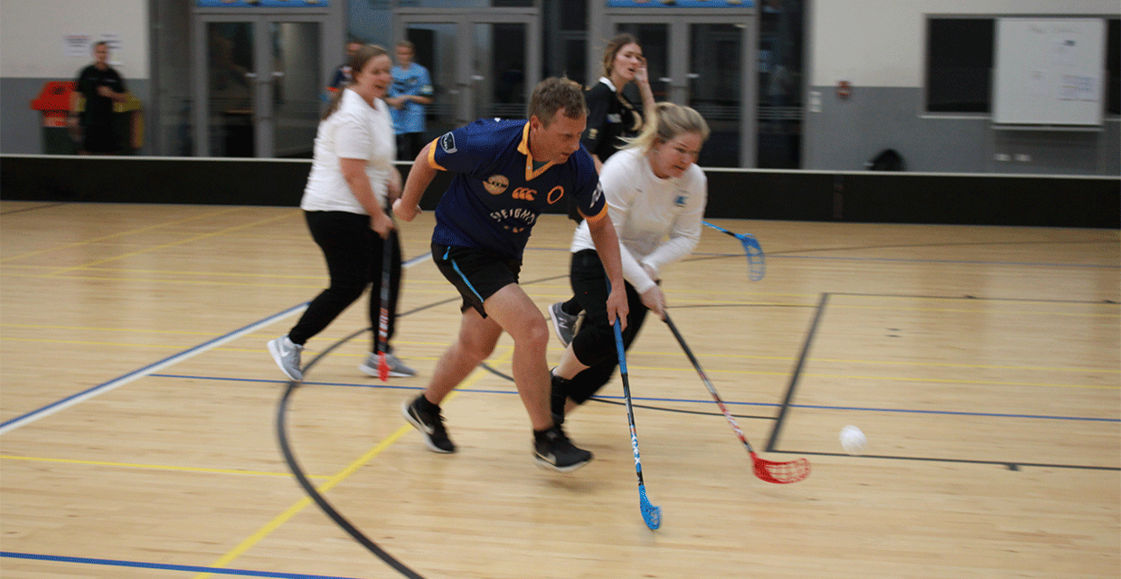 Group Of Adults Play Floorball 